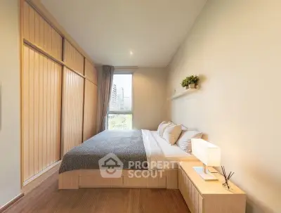 Spacious modern bedroom with large window and elegant decor