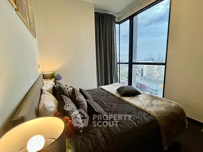Luxurious bedroom with stunning city view and elegant decor in high-rise apartment.