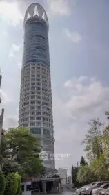 Stunning skyscraper with modern architecture and lush surroundings, perfect for urban living.