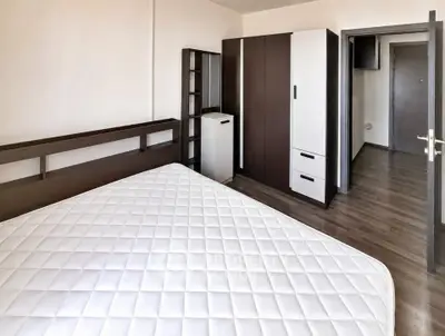 Spacious bedroom with modern furniture and wooden flooring