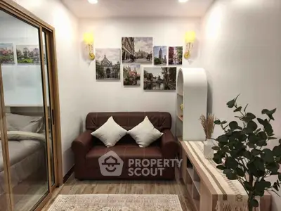 Cozy living room with brown leather sofa, decorative wall art, and modern lighting.
