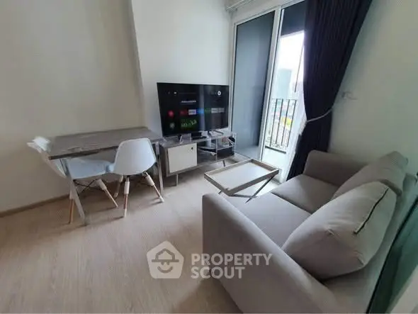 Modern living room with sleek furniture and balcony view