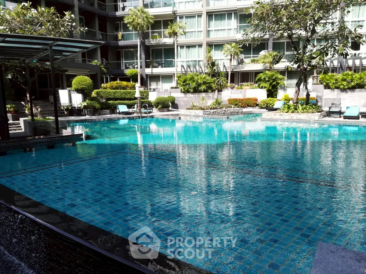 Luxurious residential pool area with lush landscaping and modern design.