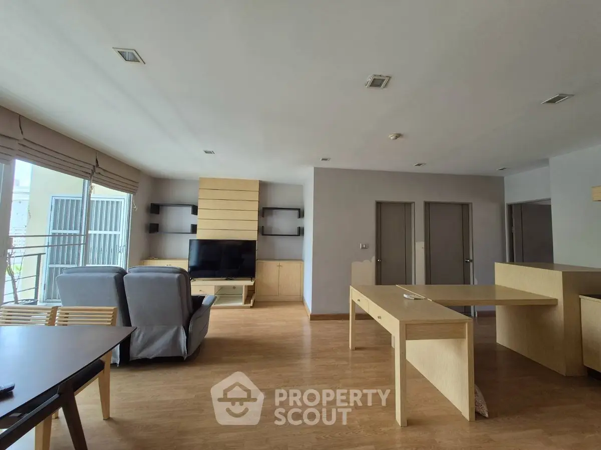 Spacious modern living room with wooden flooring and stylish furniture