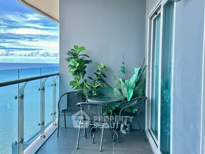 Stunning ocean view balcony with modern furniture and lush plants, perfect for relaxation and enjoying the sea breeze.