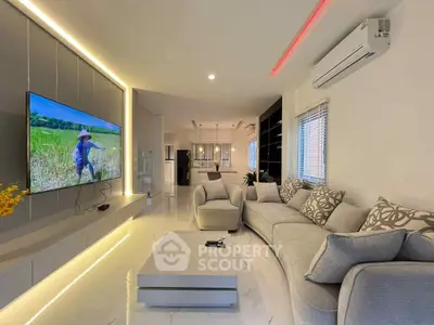 Luxurious modern living room with sleek design and large TV, perfect for relaxation and entertainment.