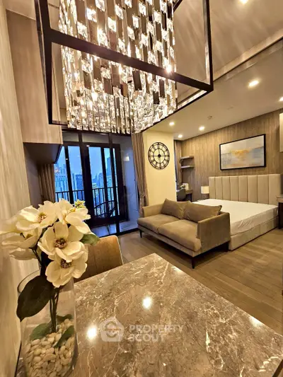 Luxurious modern bedroom with elegant chandelier and city view balcony