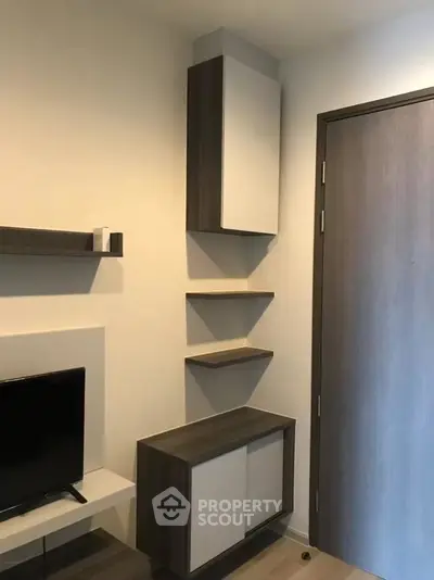 Modern living room with sleek storage cabinets and mounted TV