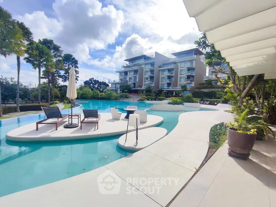 Luxurious resort-style pool area with modern apartments and lush landscaping, perfect for relaxation and leisure.