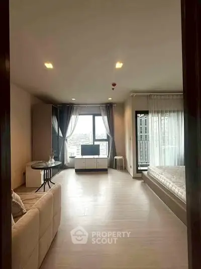 Spacious modern living room with large windows and city view