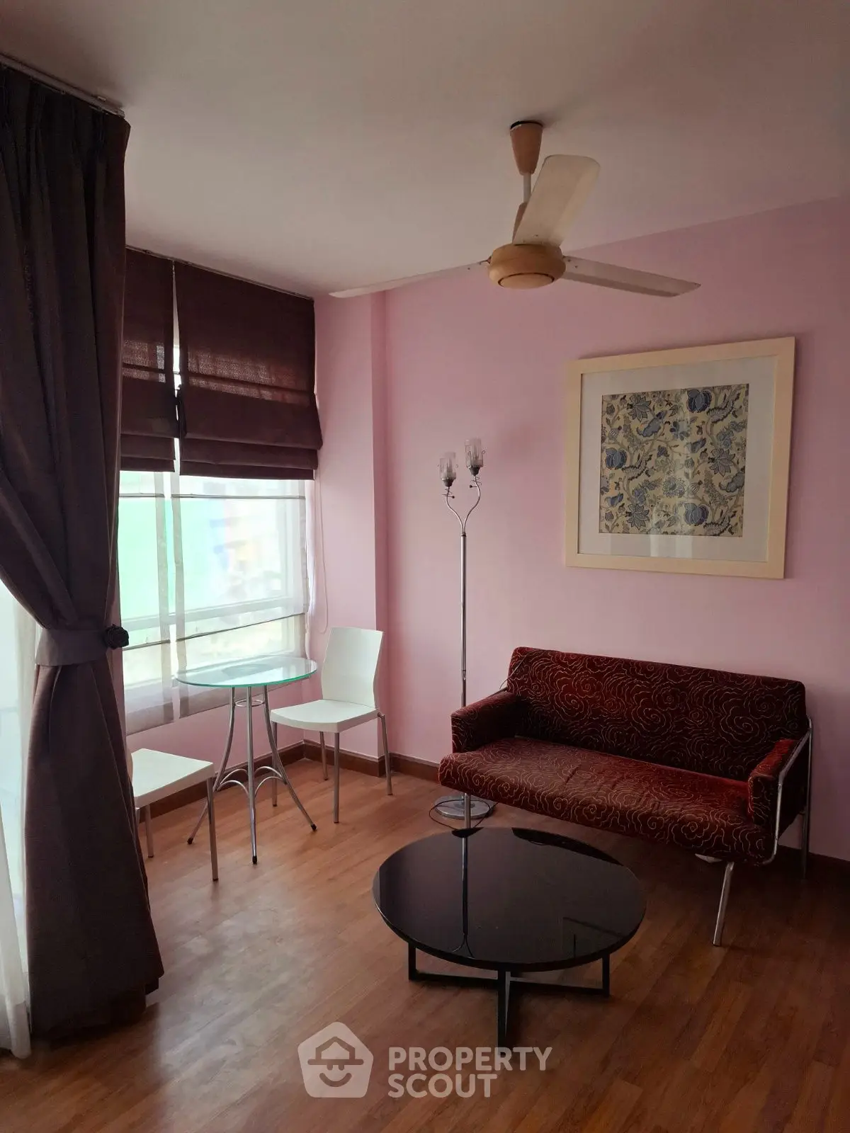 Charming living room with modern furniture and large window, perfect for relaxation.