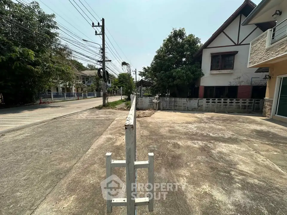Spacious residential driveway with potential for development in a suburban neighborhood.