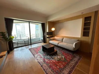 Spacious living room with modern decor and balcony view in luxury apartment.