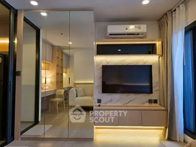 Modern living room with mirrored wall and stylish TV setup