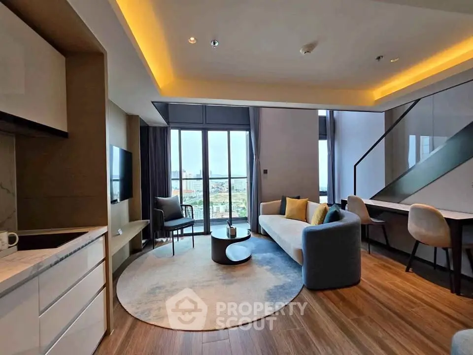 Modern living room with open layout and city view, featuring stylish furniture and elegant lighting.