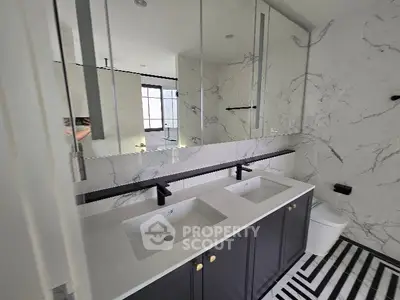 Luxurious modern bathroom with dual sinks and elegant marble accents