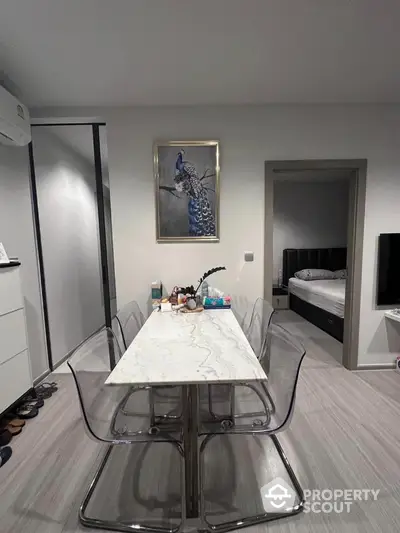 Modern dining area with marble table and transparent chairs in stylish apartment