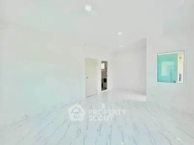 Spacious modern interior with sleek marble flooring and bright lighting, perfect for contemporary living.
