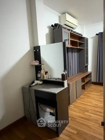 Modern bedroom with stylish wooden furniture and air conditioning unit