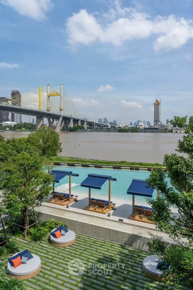 Luxurious riverside pool with stunning cityscape and bridge view, perfect for relaxation and leisure.