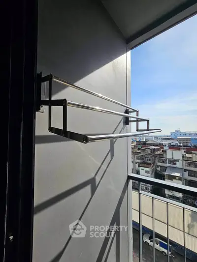 Modern balcony with sleek metal railing and urban city view, perfect for enjoying fresh air and relaxation.