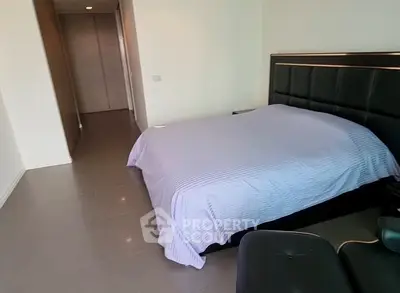 Spacious bedroom with modern design and comfortable bed in a stylish apartment.
