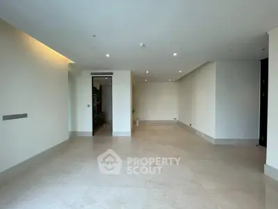 Spacious modern living room with elegant marble flooring and recessed lighting