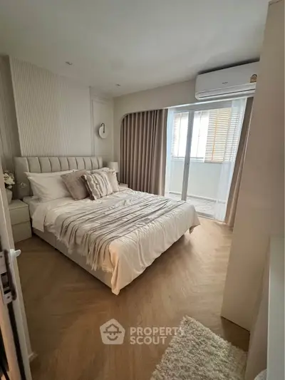 Elegant bedroom with cozy decor and balcony access in modern apartment