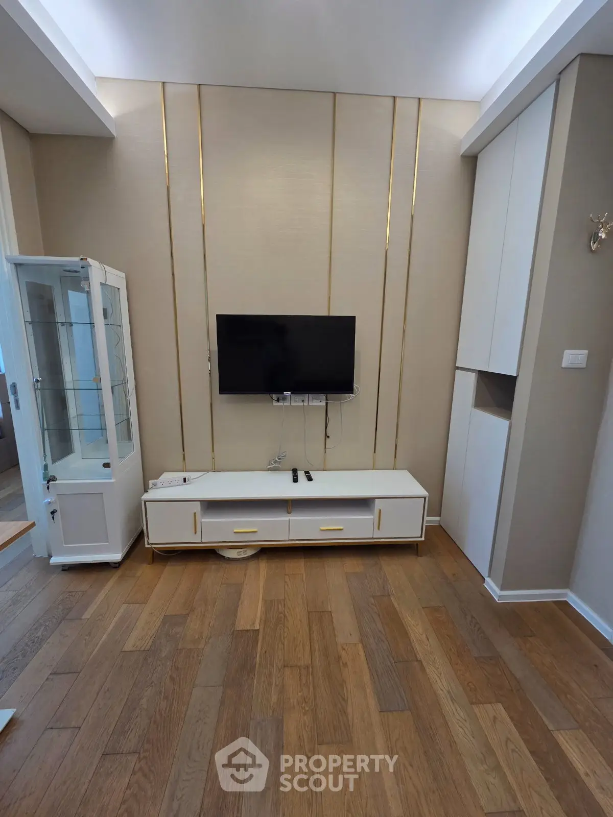 Modern living room with sleek TV setup and elegant wooden flooring