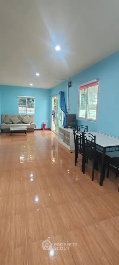 Spacious living room with modern decor and ample natural light