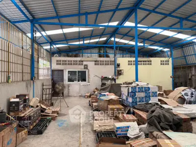 Spacious industrial warehouse with metal roof and ample storage space.