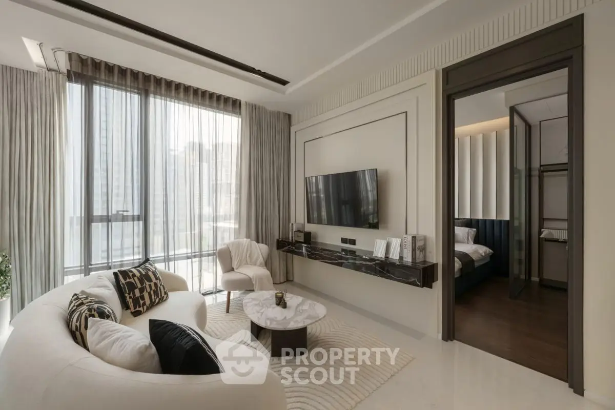 Luxurious modern living room with elegant decor and large windows offering city views.