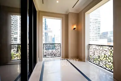 Luxurious balcony with ornate railings and cityscape view, perfect for urban living.