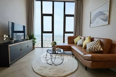 Modern living room with large windows and stylish furniture offering stunning city views.