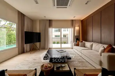 Luxurious living room with modern decor, large windows, and elegant furnishings.