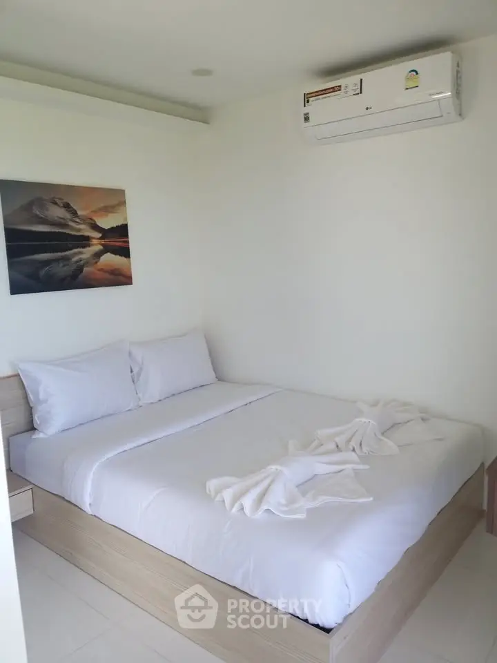 Cozy bedroom with air conditioning and modern decor, perfect for relaxation.