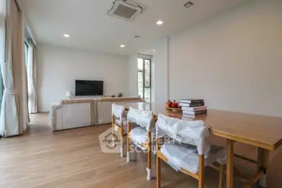 Spacious modern living room with elegant dining area and natural light