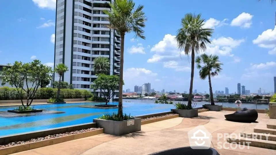 Luxurious high-rise building with stunning pool and city view, perfect for urban living.