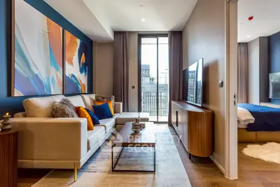 Modern living room with stylish decor and large window offering city view