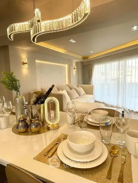 Luxurious dining area with elegant table setting and modern chandelier in a stylish living room.