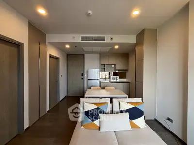 Modern open-plan living room with stylish kitchen and cozy seating area.