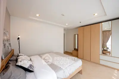 Spacious bedroom with modern decor and ample natural light