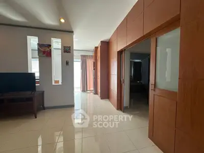 Spacious modern living area with wooden accents and natural light