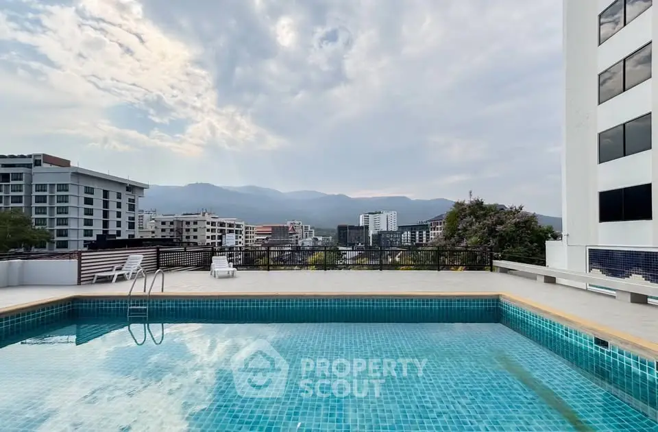 Stunning rooftop pool with panoramic city and mountain views, perfect for relaxation and leisure.