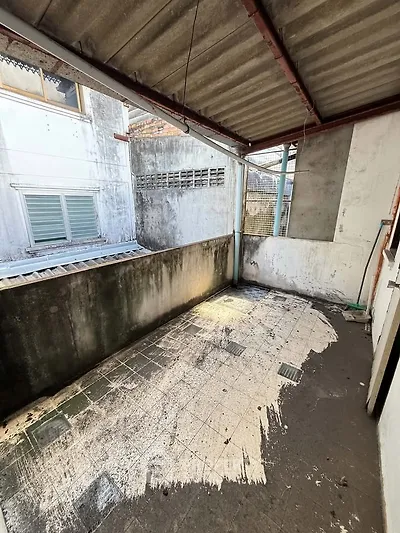 Spacious outdoor balcony area with potential for renovation and personalization.