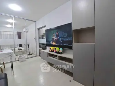 Modern living room with sleek TV unit and glass partition, offering a cozy and stylish ambiance.