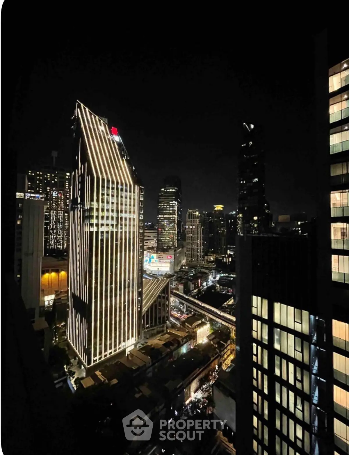 Stunning night view of illuminated city skyscrapers showcasing modern architecture and vibrant urban life.