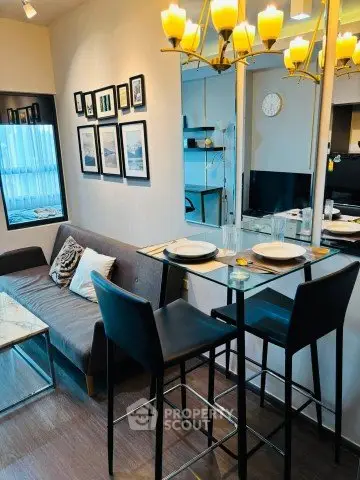 Modern living room with stylish decor and dining area in a cozy apartment setting.