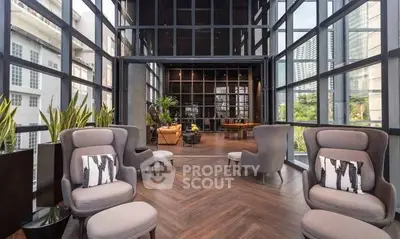 Luxurious modern living room with floor-to-ceiling windows and elegant seating area.