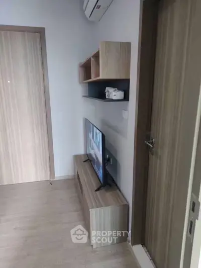 Modern living room with sleek wooden furniture and mounted TV, perfect for cozy urban living.